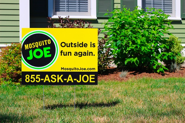 Mosquito Joe yard sign and service van displayed in front a Virginia home.